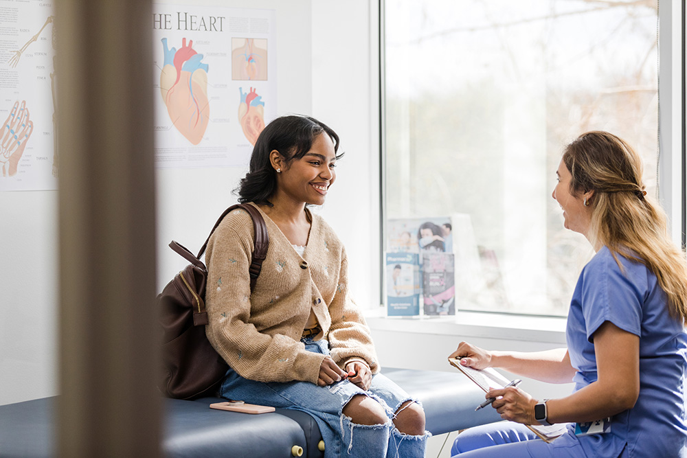 A young woman meets with a Healthfirst service provider