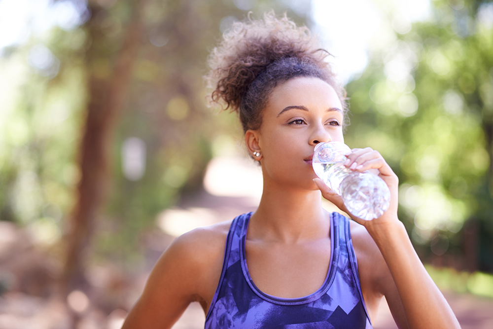 Young woman drinking a bottle of water